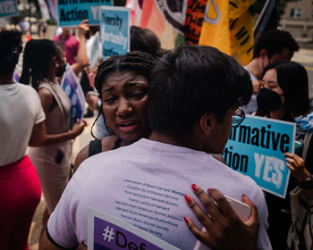 Two people holding voter outreach materials