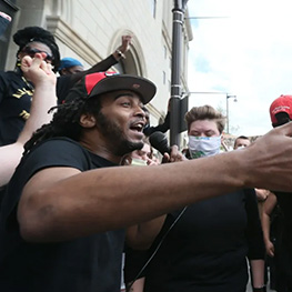 Three people holding community outreach flyers