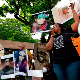 Three people holding community outreach flyers